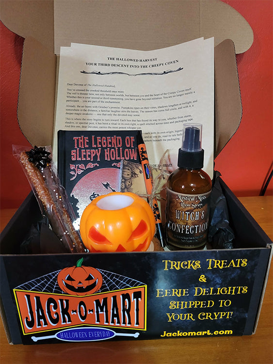 Jack-o-Mart Halloween subscription box featuring spooky gifts, vintage Halloween items, and Creepy Coven packaging